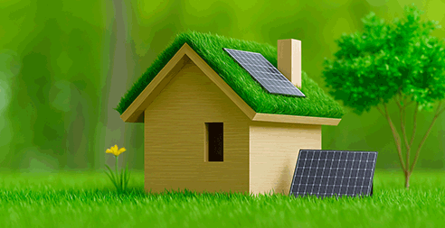 Maison miniature écologique avec toit végétalisé et panneaux solaires, sur pelouse verte avec fond naturel flou